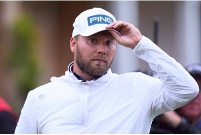 Dan Brown acknowledges the crowd after holing his birdie putt on the 18th hole at Royal Troon.