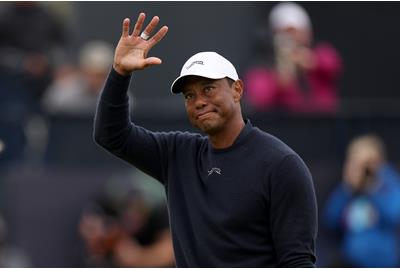 Tiger Woods acknowledges the crowd on the 18th hole at Royal Troon after missing the cut.