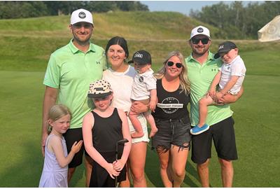 Dylan Thornborough and Patrick Law celebrated with their families after breaking the world record for the most holes of golf played in 12 hours.