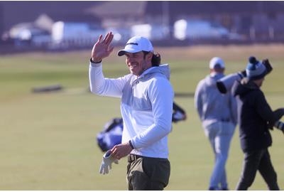 Welsh former footballer Gareth Bale waves on the fairway of the first hole of the Old Course, St Andrews