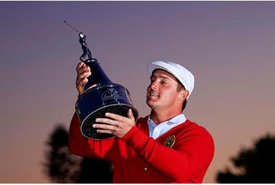 Bryson DeChambeau lifts the Arnold Palmer Invitational trophy.